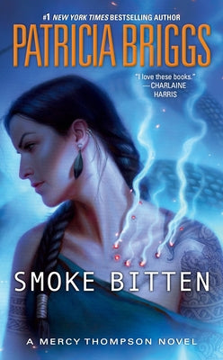 Paperback of "Smoke Bitten" by Ace Books, featuring the book cover with dark and smoky design elements.