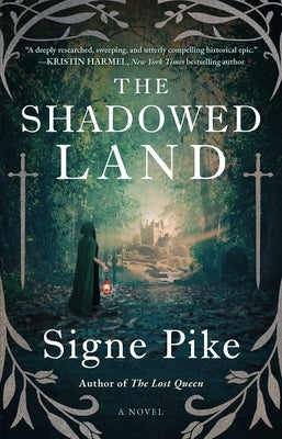 Paperback copy of The Shadowed Land novel by Atria Books with a dark, atmospheric cover design.