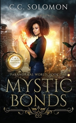 Paperback copy of Mystic Bonds Second Edition by CC Solomon, featuring the book's cover with mystical artwork.