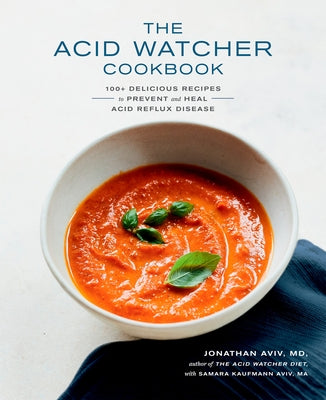 Paperback copy of The Acid Watcher Cookbook by Harmony featuring colorful pages and recipe illustrations for acid reflux relief.