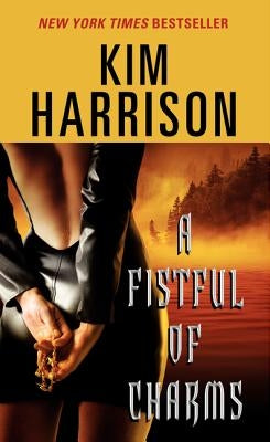 Paperback edition of "A Fistful of Charms" by HarperTorch featuring the book cover with title and author details.