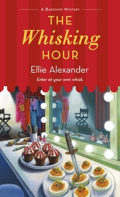 Mass market paperback of "The Whisking Hour" Bakeshop Mystery by Minotaur Books, featuring a cozy bakery scene on the cover.