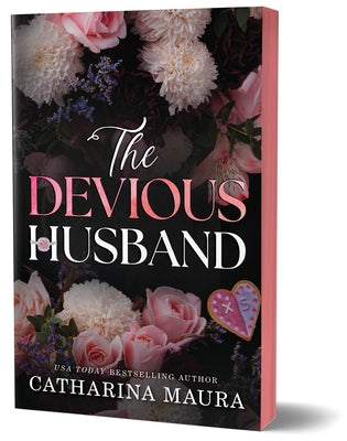 Paperback of The Devious Husband Deluxe Edition by Bloom Books featuring a close-up of the book cover with intricate design elements.