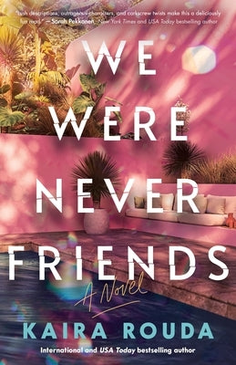 Paperback copy of "We Were Never Friends" novel published by Poisoned Pen Press, featuring a cover with dark and moody artwork.