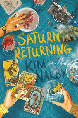 Paperback of Saturn Returning by Bindery Books, featuring the book cover with celestial illustrations and title on the front.