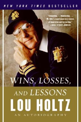 Paperback of "Wins, Losses, and Lessons" autobiography by Dey Street Books, featuring the book cover with title and author's name.