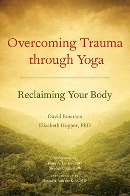 Paperback book titled "Overcoming Trauma Through Yoga: Reclaiming Your Body" by North Atlantic Books on trauma recovery and yoga.