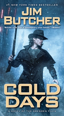 Paperback copy of "Cold Days" by Roc, featuring the book cover with dark, atmospheric artwork.