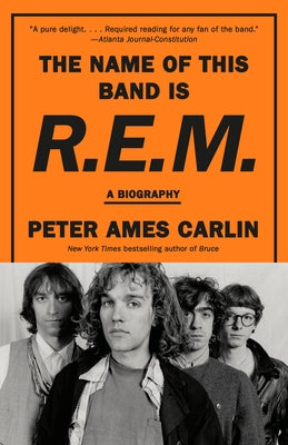 Paperback biography of R.E.M. titled "The Name of This Band Is R.E.M." by Vintage, showing the book cover with title and author.