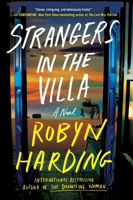 Paperback of "Strangers in the Villa" by Grand Central Publishing, showing the front cover with title and author details.