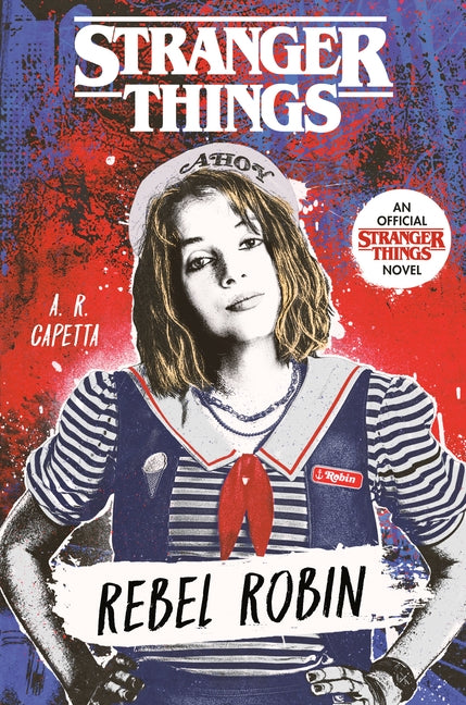 Paperback copy of Stranger Things: Rebel Robin by Ember featuring the book cover with Robin and Eleven on the front.