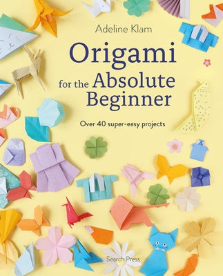 Open paperback book titled "Origami for the Absolute Beginner" by Search Press, showing colorful origami paper and folded models inside.