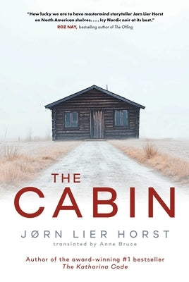 Paperback copy of The Cabin book by Scribner Canada featuring a cover with a rustic cabin illustration.