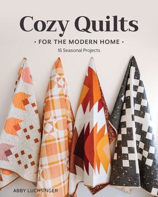Paperback quilt book titled "Cozy Quilts for the Modern Home" by Stash Books featuring colorful seasonal quilt projects.