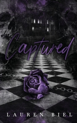 Lauren Biel's Captured paperback book with a cover featuring an artistic design, resting on a plain surface.