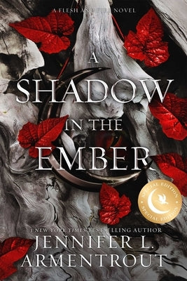 Paperback copy of "A Shadow in the Ember" Special Edition by Blue Box Press, showing the book's cover with dark, fiery artwork.