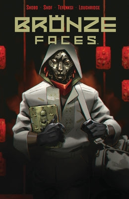 Paperback of Bronze Faces comic book by Boom! Studios, featuring cover art with bronze-colored faces and intricate design.