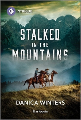 Mass market paperback novel "Stalked in the Mountains" by Harlequin Intrigue, featuring a mountain landscape on the cover.