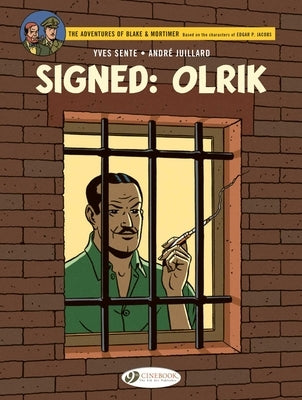 Signed paperback of Olrik comic book by Cinebook Ltd, showing the front cover with artwork and signature.