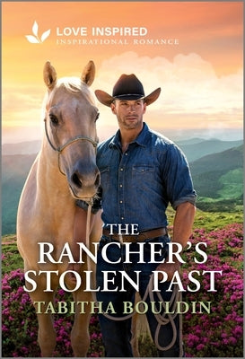 Cover of The Rancher's Stolen Past inspirational romance novel by Love Inspired, featuring a scenic rural landscape with a barn and sunset.