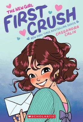 Paperback graphic novel "The New Girl: First Crush" by Graphix, featuring colorful cover art with illustrated characters.