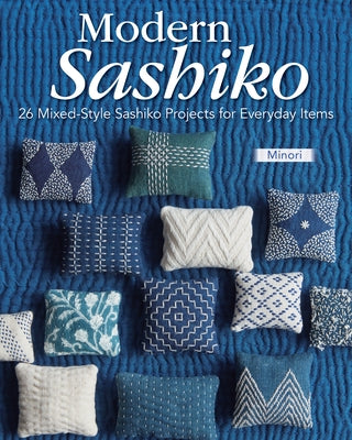 Open paperback book titled "Modern Sashiko" showing colorful sashiko stitching patterns on white fabric pages.