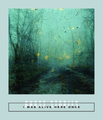 Paperback copy of "I Was Alive Here Once: Ghost Stories" by Two Lines Press showing the book cover with haunting ghost illustrations.