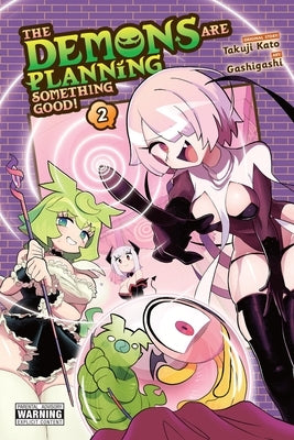 Paperback of "The Demons Are Planning Something Good! Vol. 2" manga by Yen Press, featuring colorful cover art and illustrated pages.