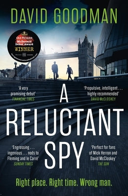 Paperback of "A Reluctant Spy" thriller novel by Headline, showing the book cover with title and author details.