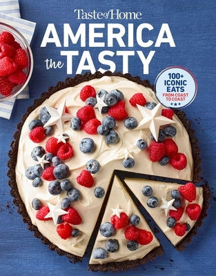 Paperback cookbook titled "Taste of Home America the Tasty" by Trusted Media Brands, featuring colorful pages with American recipes.