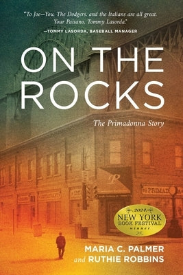 Paperback copy of "On the Rocks: The Primadonna Story" by Koehler Books, featuring the book cover with title and author branding.