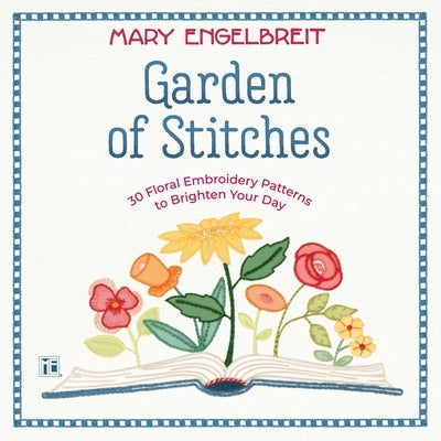 Open paperback book titled "Garden of Stitches" with colorful floral embroidery patterns on its pages, displayed on a wooden surface.