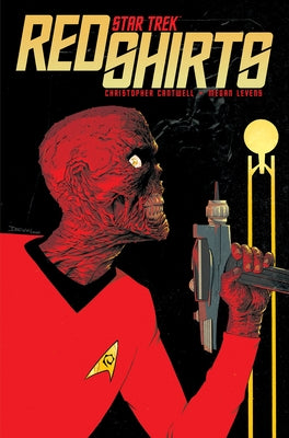 Paperback copy of "Star Trek: Red Shirts" comic book by IDW Publishing with cover art featuring starship and crew members.