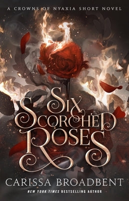 Paperback copy of Six Scorched Roses: A Crowns of Nyaxia Short Novel by Bramble, showing the book cover with dark rose imagery.