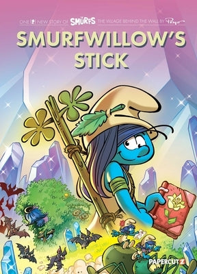 Paperback book titled "The Smurfs Village Vol. 5: Smurfwillow's Stick" by Papercutz, featuring colorful Smurfs characters on the cover.