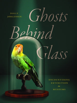 Paperback book titled "Ghosts Behind Glass: Encountering Extinction in Museums" by University of Chicago Press, with cover art visible.