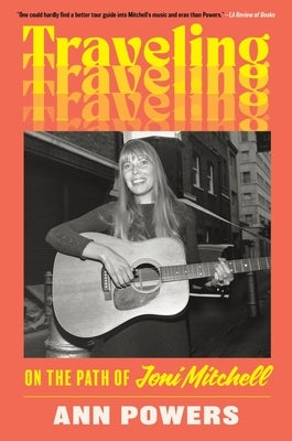 Paperback book titled Traveling: On the Path of Joni Mitchell by Dey Street Books, featuring a cover image with artistic design.