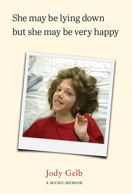 Paperback book titled "She May Be Lying Down But She May Be Very Happy" by Kelson Books, showing the front cover.