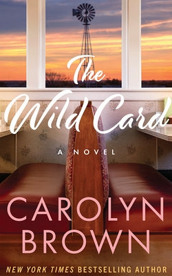 Paperback of "The Wild Card" by Montlake featuring a cover with bold title text and a scenic background.