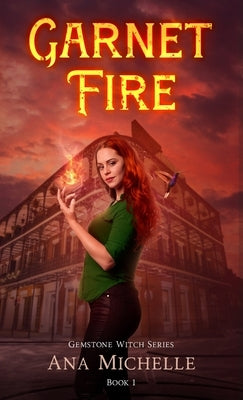 Paperback copy of Garnet Fire by Paradisum Publishing, featuring the book's cover with fiery red and orange design.